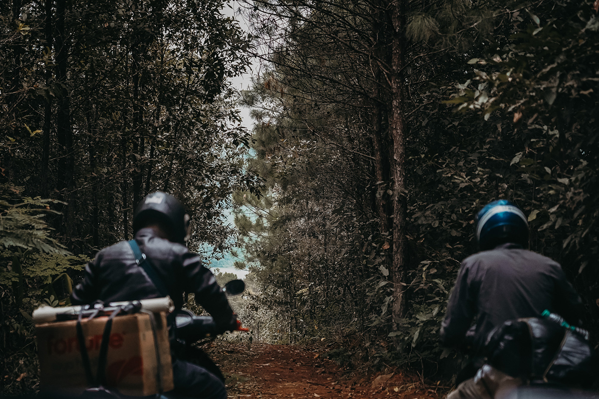 two men on a motorbike with persecution preparedness training materials